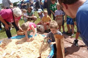 Children search for treasures in the Sawdust Pile